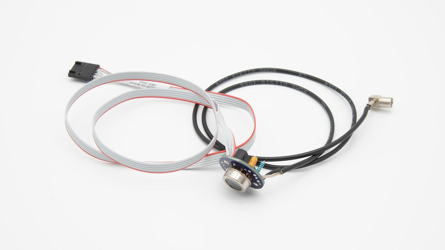 A small cable and wire are connected to a white surface, showcasing their intricate arrangement and connection.