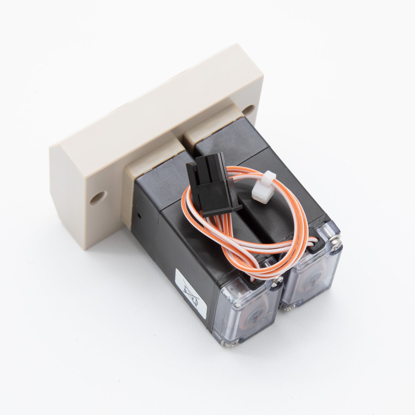 A white and black electrical device with visible wires, showcasing its intricate design and functionality.