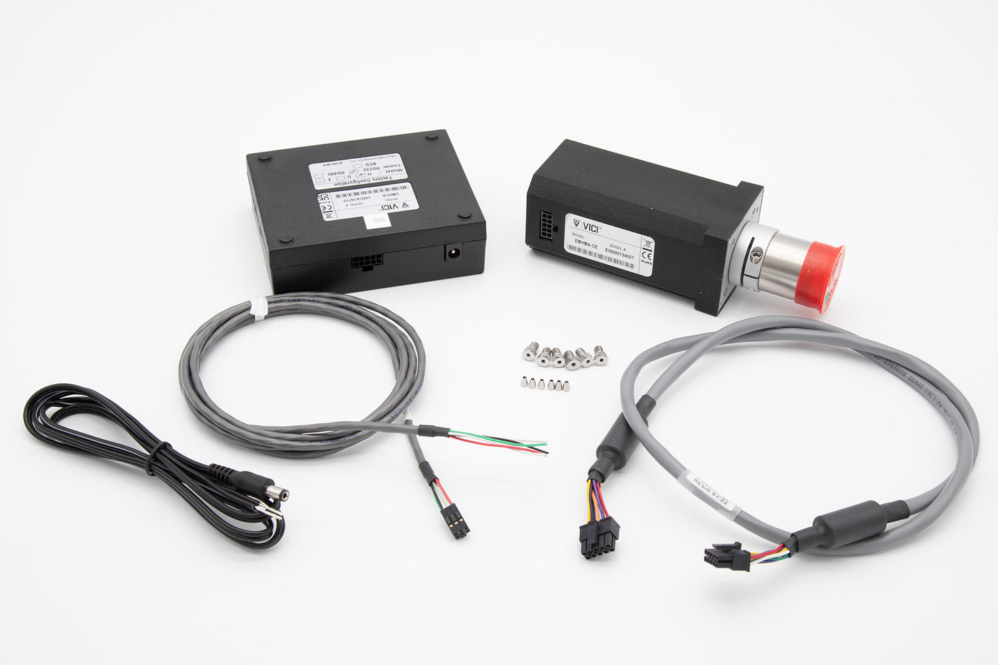 A valve with red cap, control module box and two separate cables intended for specific operational tasks.