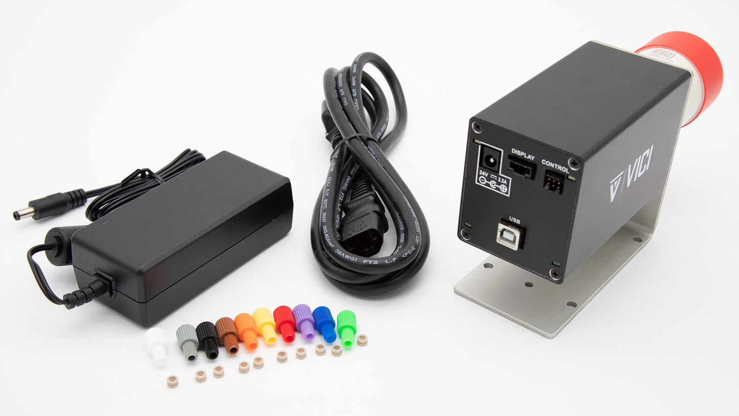 Black valve controller, AC power converter with cord and plastic connection pieces.