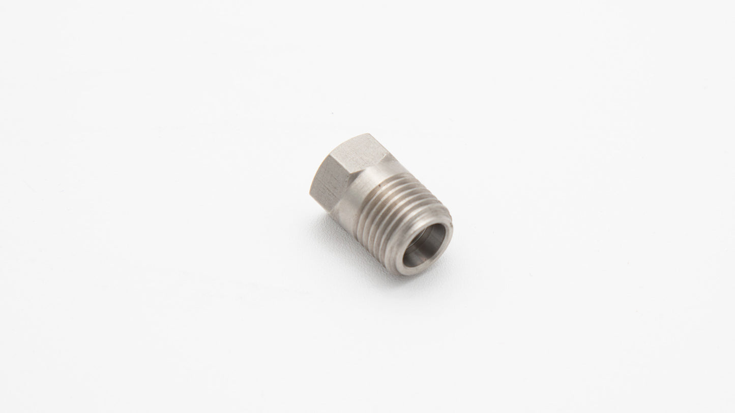 A stainless steel threaded nut resting on a clean white surface, showcasing its metallic texture and precise threading.