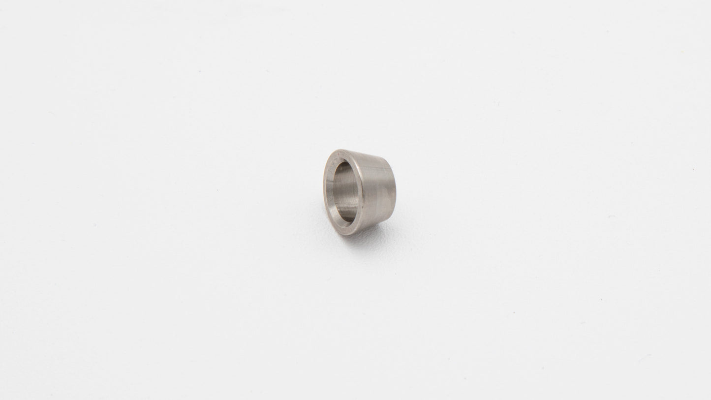 A small metal ring resting on a clean white surface, showcasing its shiny texture and circular form.