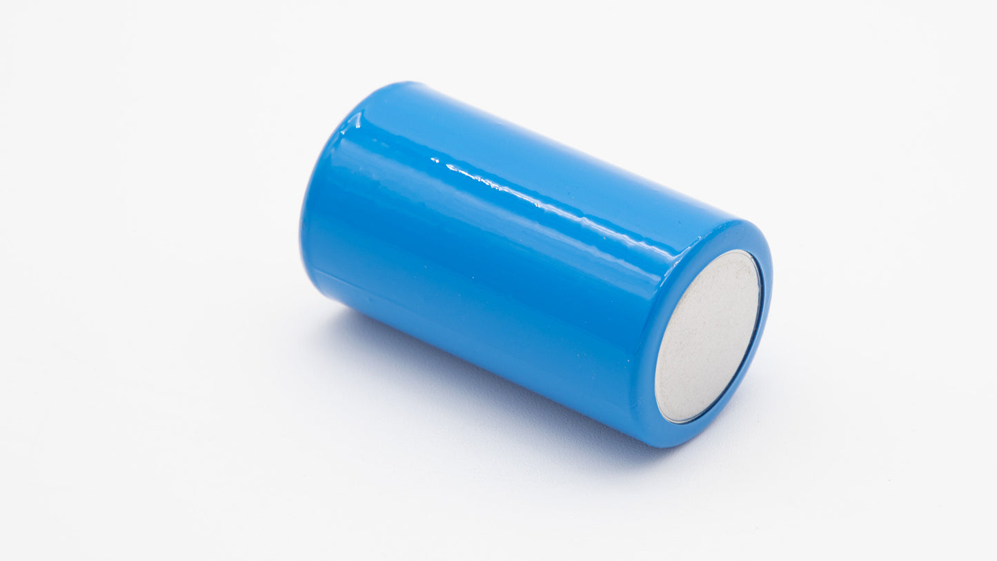 A blue cylindrical battery placed upright on a clean white surface, showcasing its smooth exterior and vibrant color.