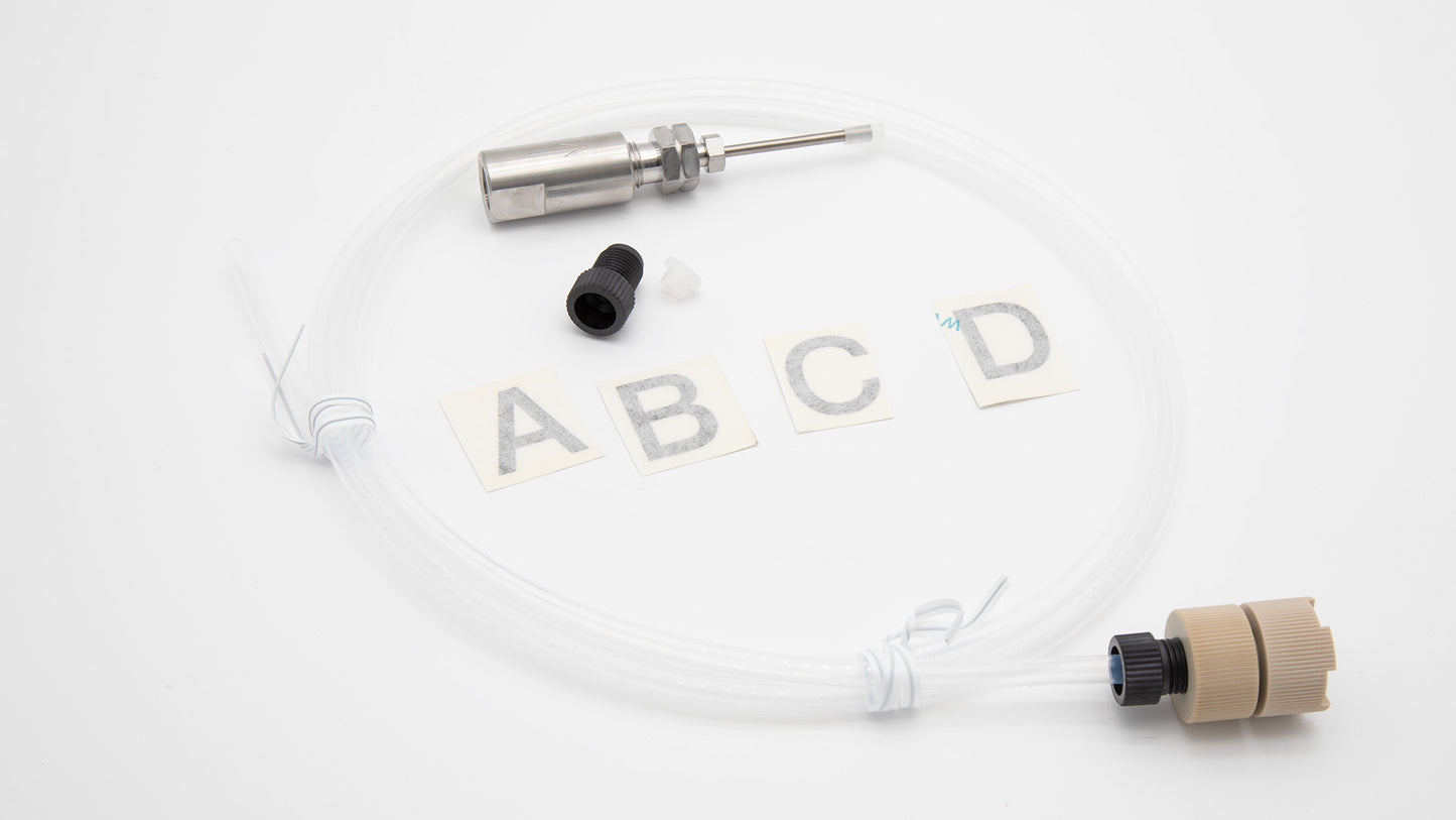 A small hose connected to a needle and a short piece of tubing, showcasing a compact assembly for fluid transfer.