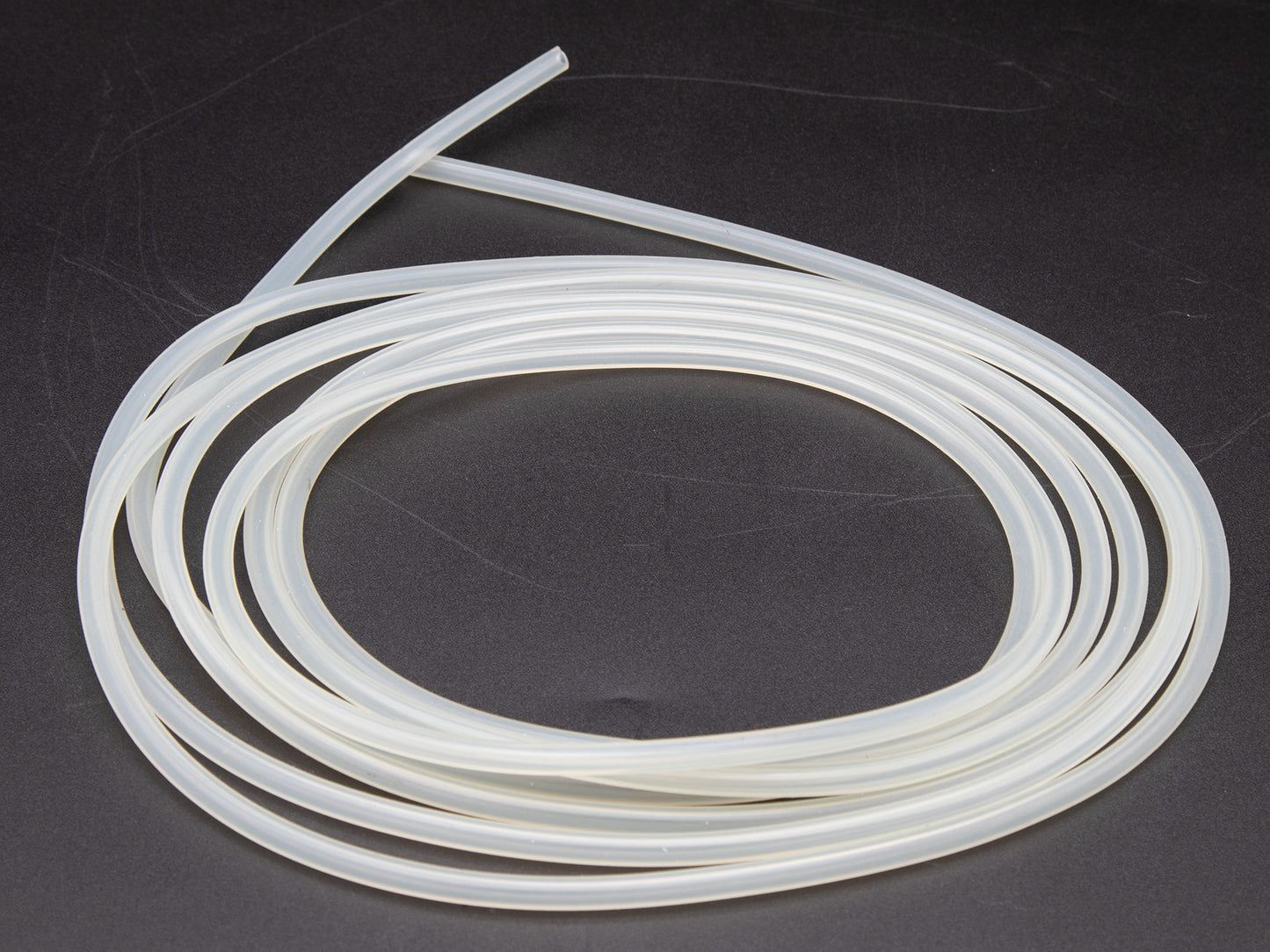 A white plastic tube featuring a long end, positioned against a neutral background for clarity.