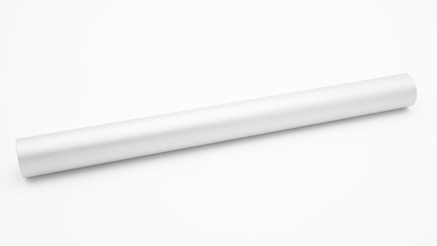A white tube rests on a clean white surface, showcasing a minimalist design.