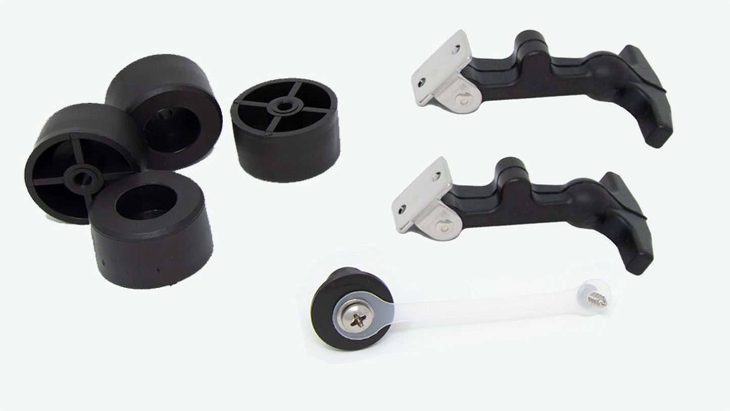 A set of four black plastic wheels and handles arranged neatly alongside a plug with strap, showcasing their design and material.