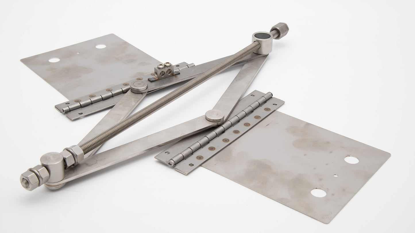 A pair of metal clamps resting on a clean white surface, showcasing their sleek design and sturdy construction.