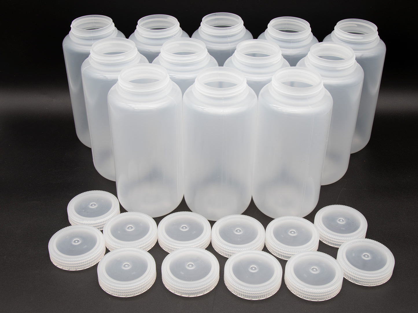 A set of plastic bottles with lids displayed together, highlighting their uniformity and distinct designs.