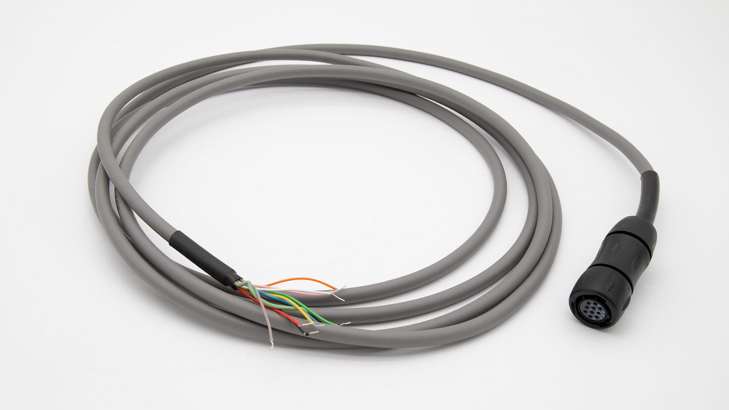 A close-up of a cable with a connector and wire positioned on a white surface.