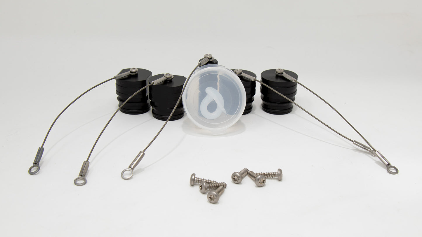 A set of black caps with wires and screws displayed side by side, highlighting their unique designs and contrasting colors.