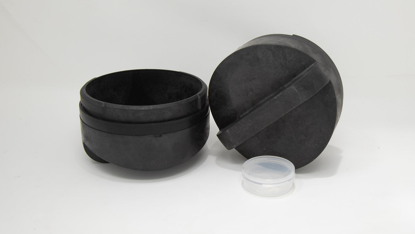 Two black plastic caps neatly placed side by side, showcasing their sleek and functional design.