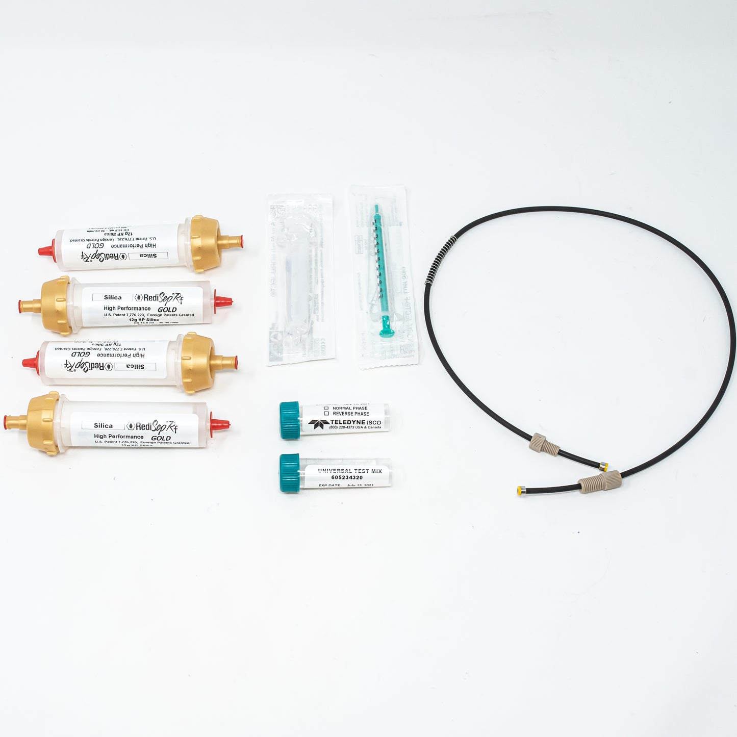 A diverse collection of laboratory items, including columns, tubing, and syringes, displayed together.
