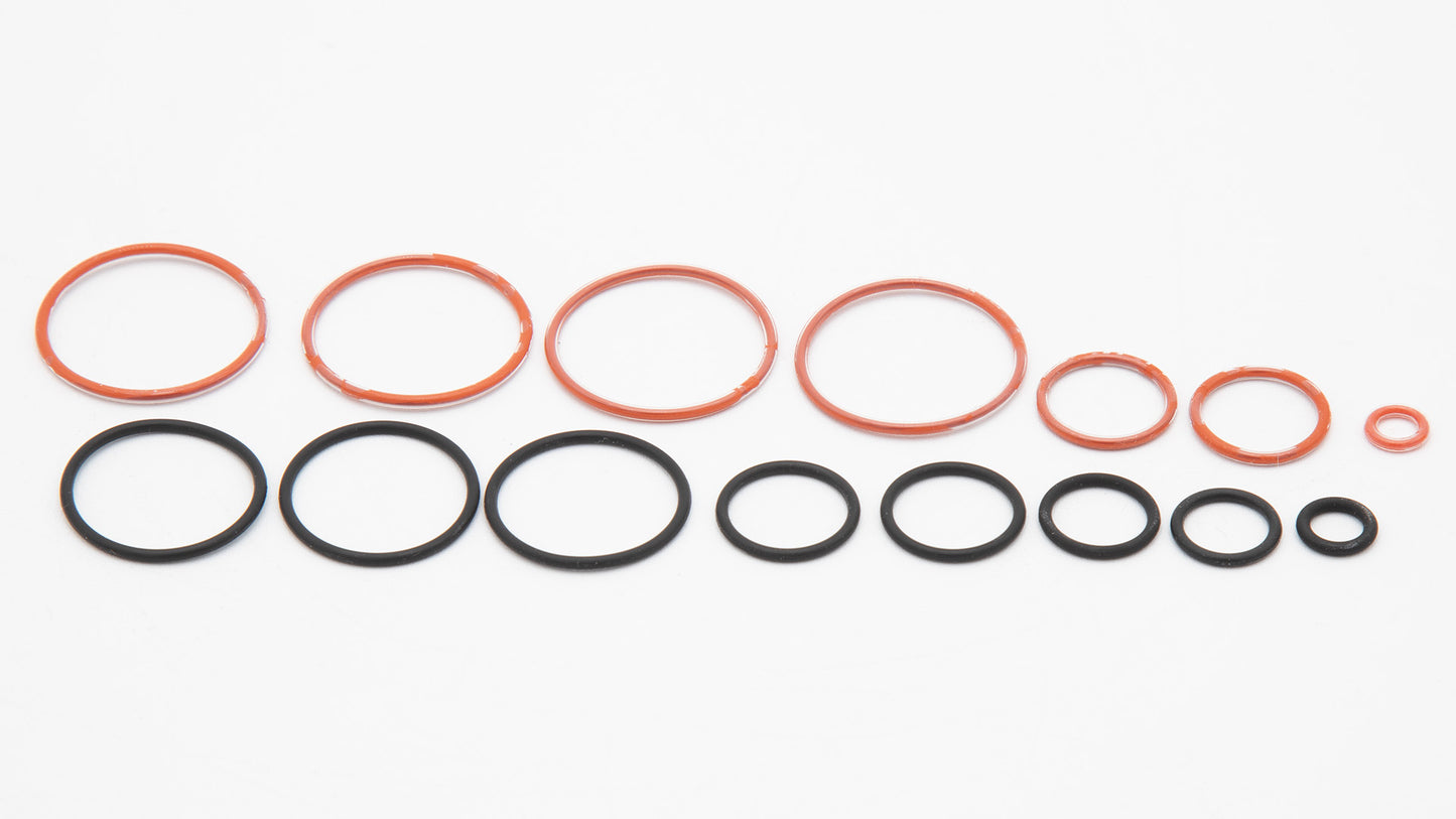 A collection of orange and black round objects in varied sizes