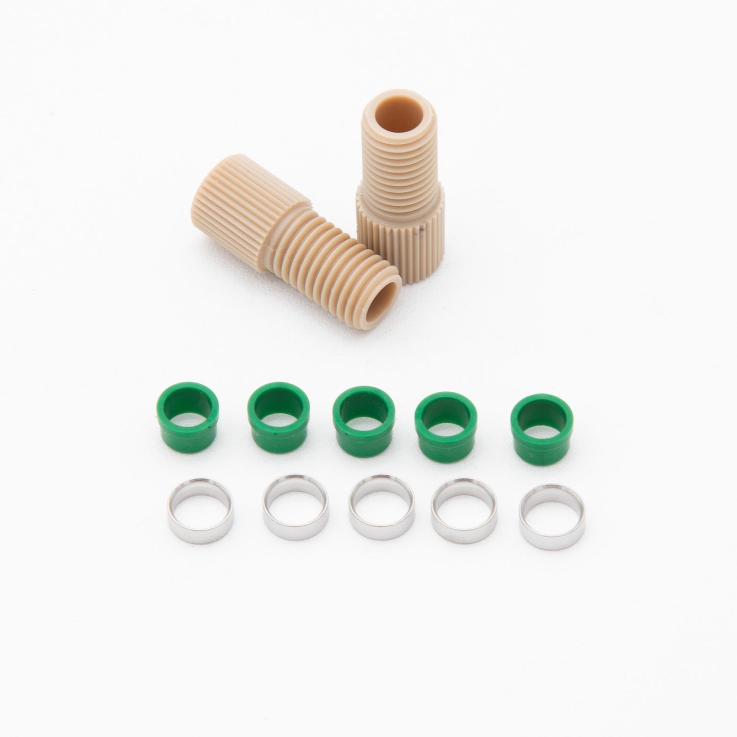 A collection of green and tan plastic fittings arranged neatly on a surface, showcasing their varied shapes and sizes.