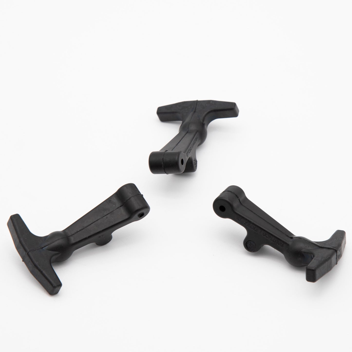 Three black plastic clips arranged neatly on a clean white surface, showcasing their simple design and functionality.