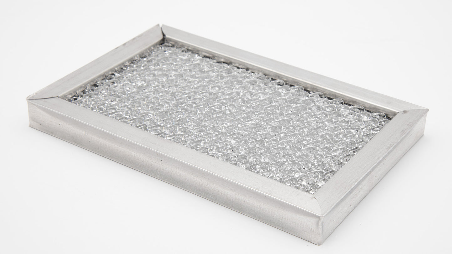 A silver metal filter placed on a clean white surface, showcasing its sleek design and reflective quality.