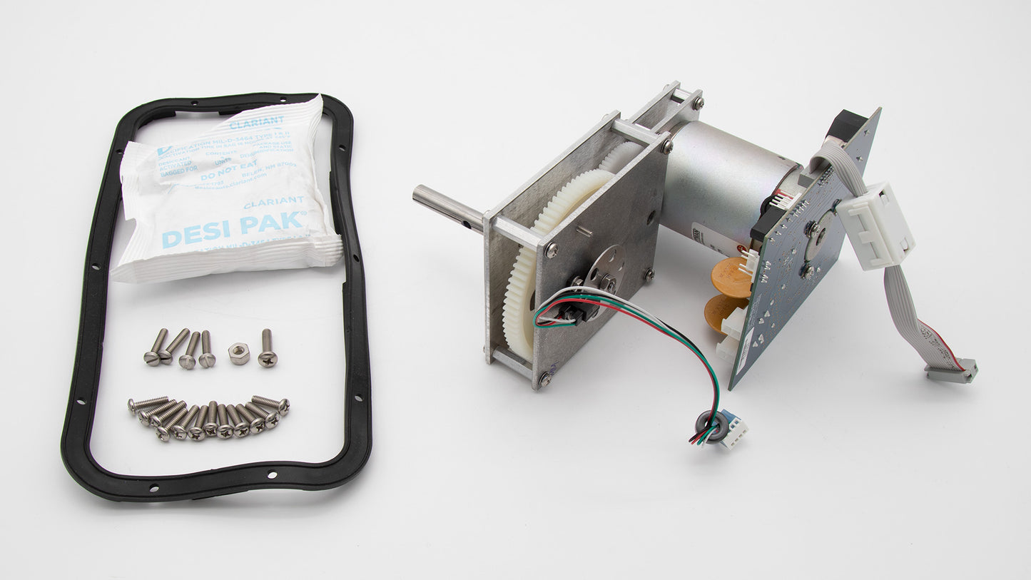A small electronic device accompanied by screws and a bag, showcasing its compact design and essential components.
