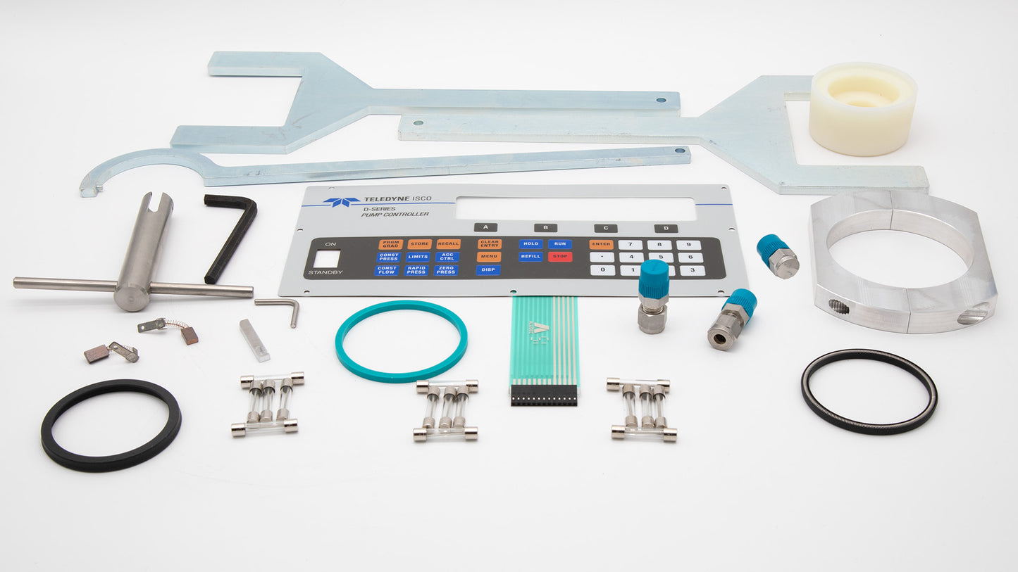 A collection of components featuring a keypad, wrench set, seals, fuses and other items on a clean surface.