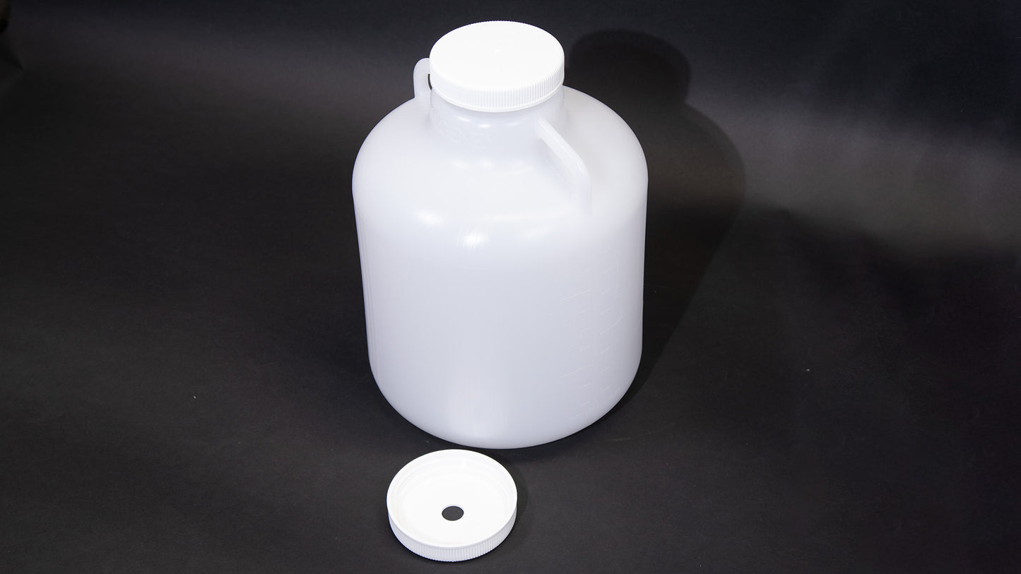 A white plastic bottle featuring two caps, suitable for various liquid contents.