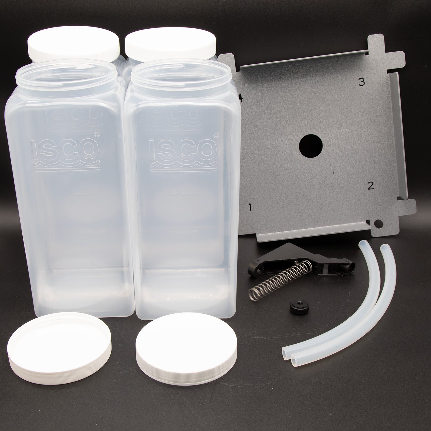 A set of four clear plastic containers arranged neatly with a locating platform and other assorted items, showcasing their transparent design.