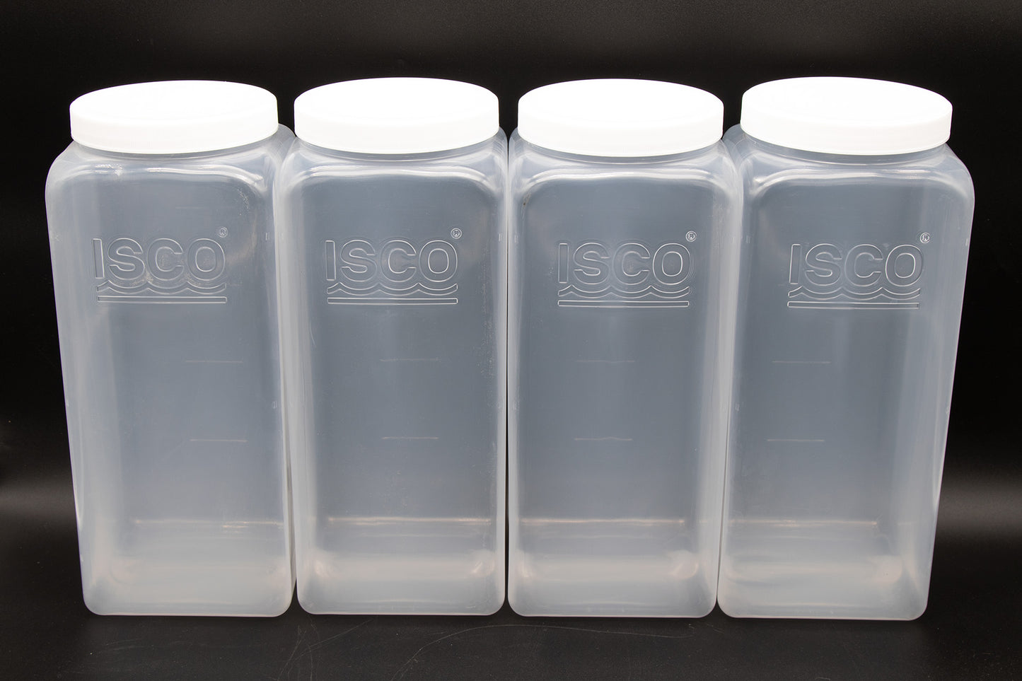 Four clear plastic storage containers with secure lids, positioned side by side to emphasize their practical design.