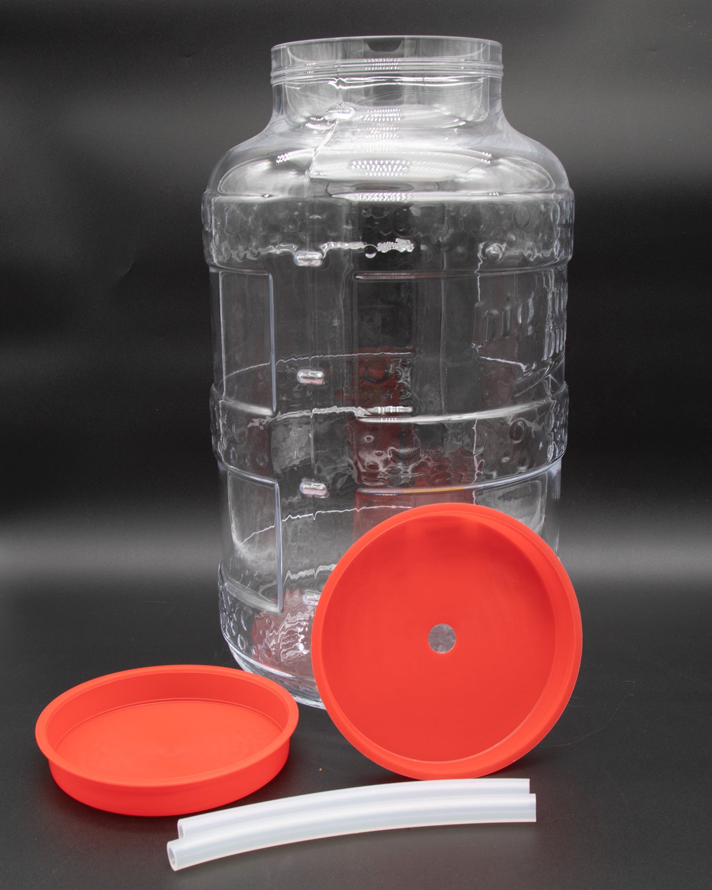 A large glass container featuring bright red lids, suitable for storage and organization purposes.