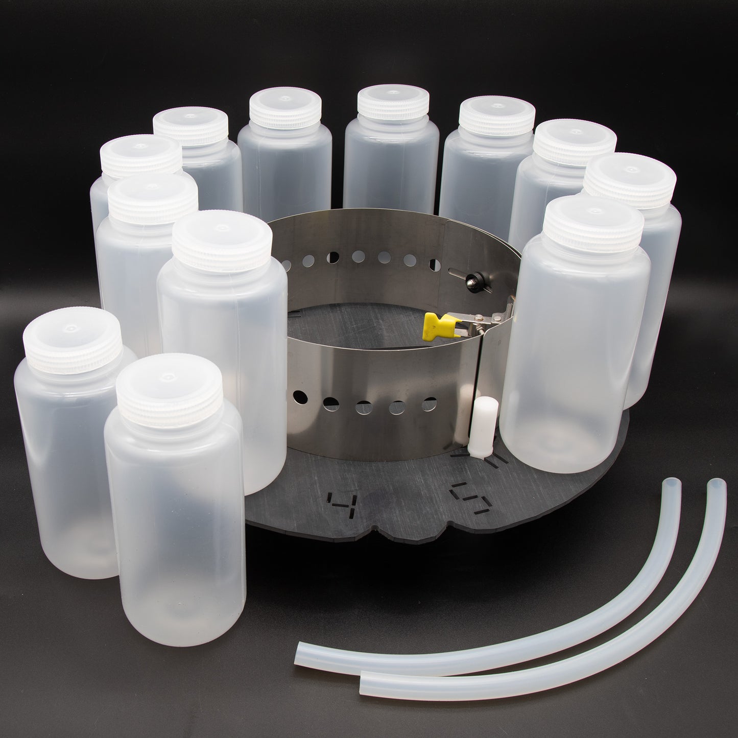 A circular tray displaying multiple plastic bottles and a hose arranged neatly on its surface.