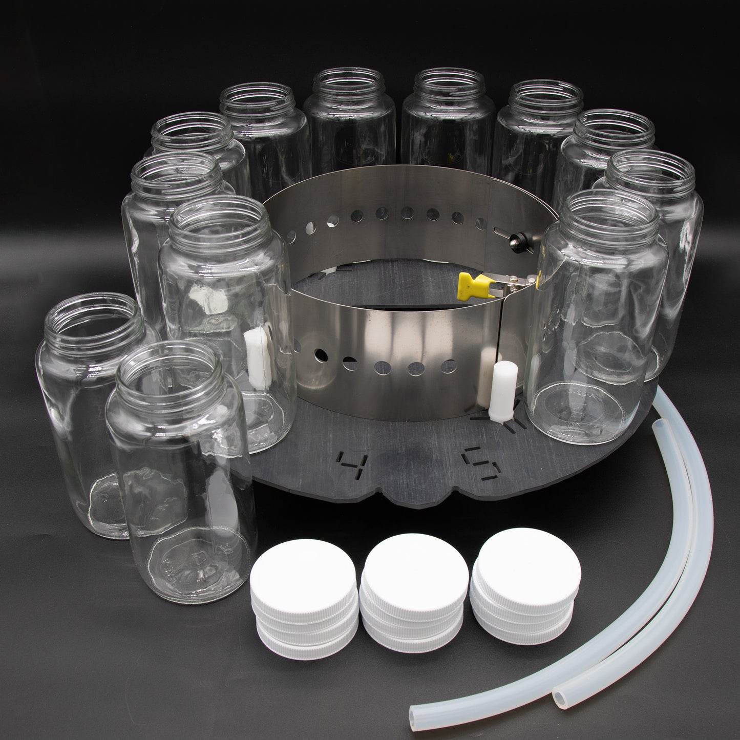 A circular tray displaying multiple jars and a hose arranged neatly on its surface.