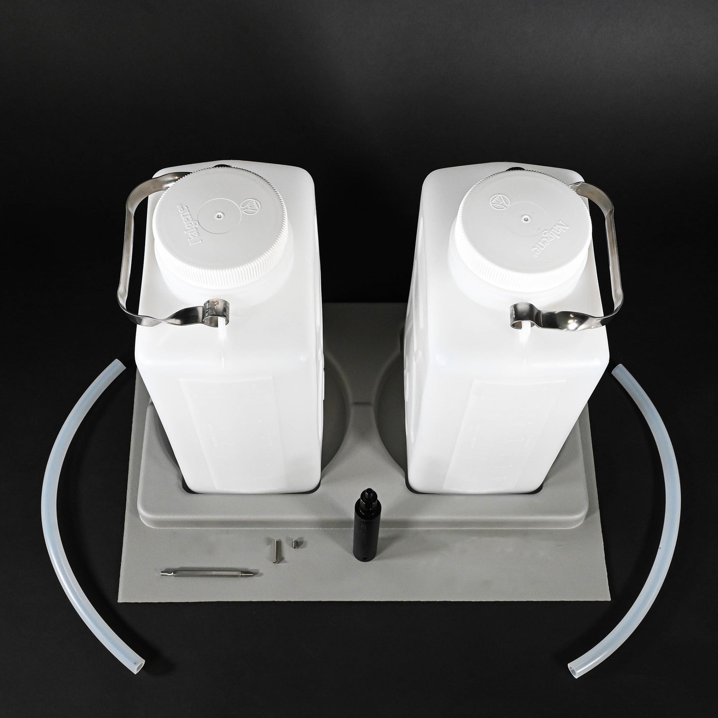 Two white water jugs placed in a grey holder, emphasizing their elegant and functional appearance.