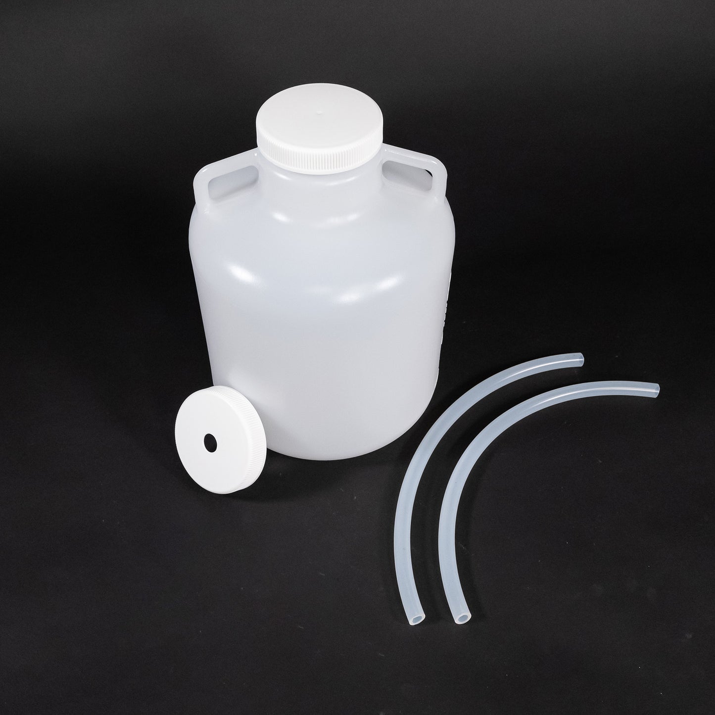 A plastic jug, hoses, and hardware displayed together, highlighting their functional design and utility.