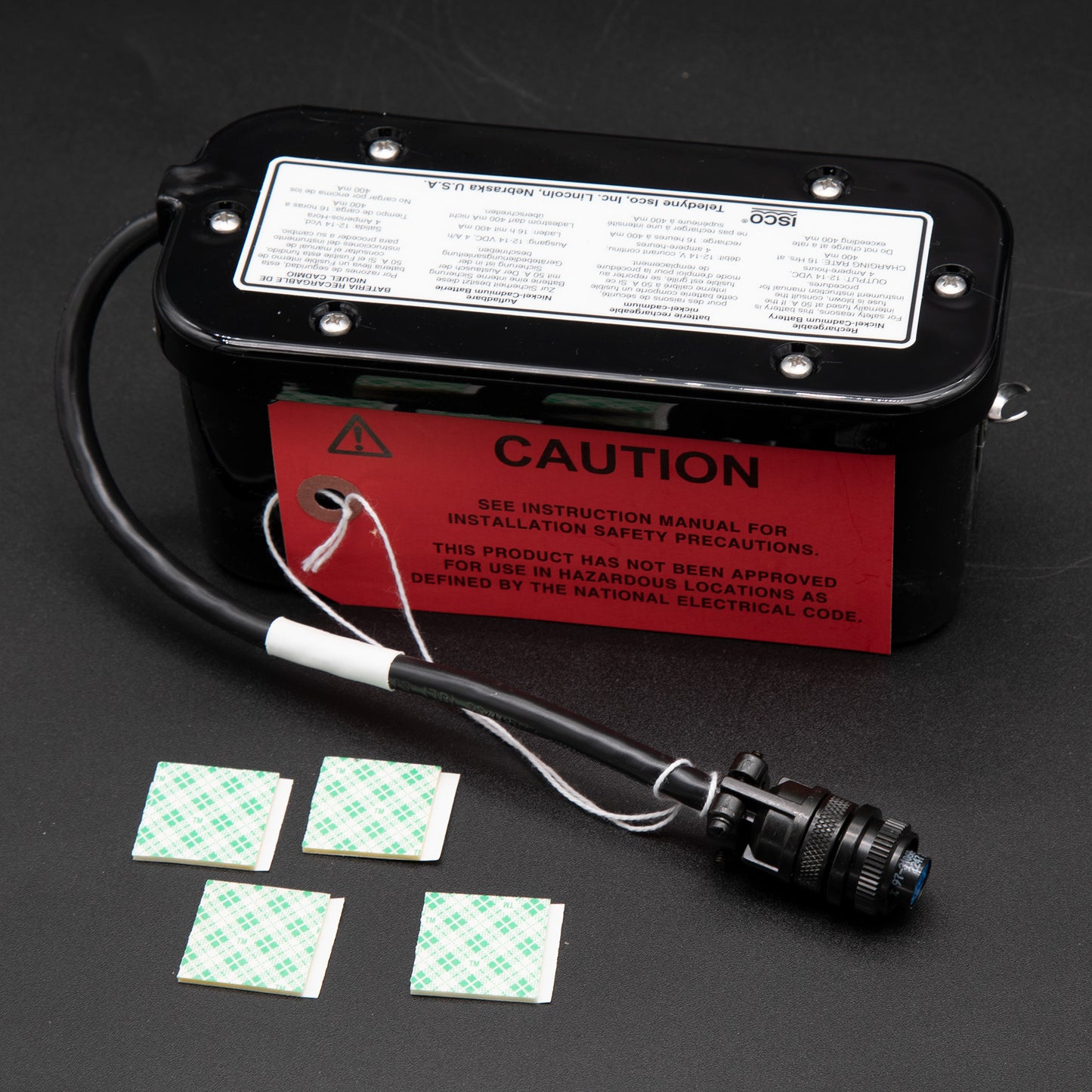 A battery featuring a warning label and a small small label affixed to its surface, indicating caution.