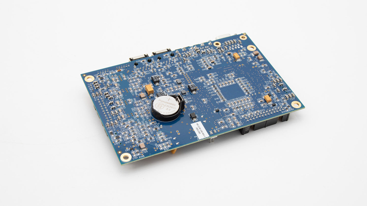 A small electronic board resting on a white surface, emphasizing its various components and technical features.