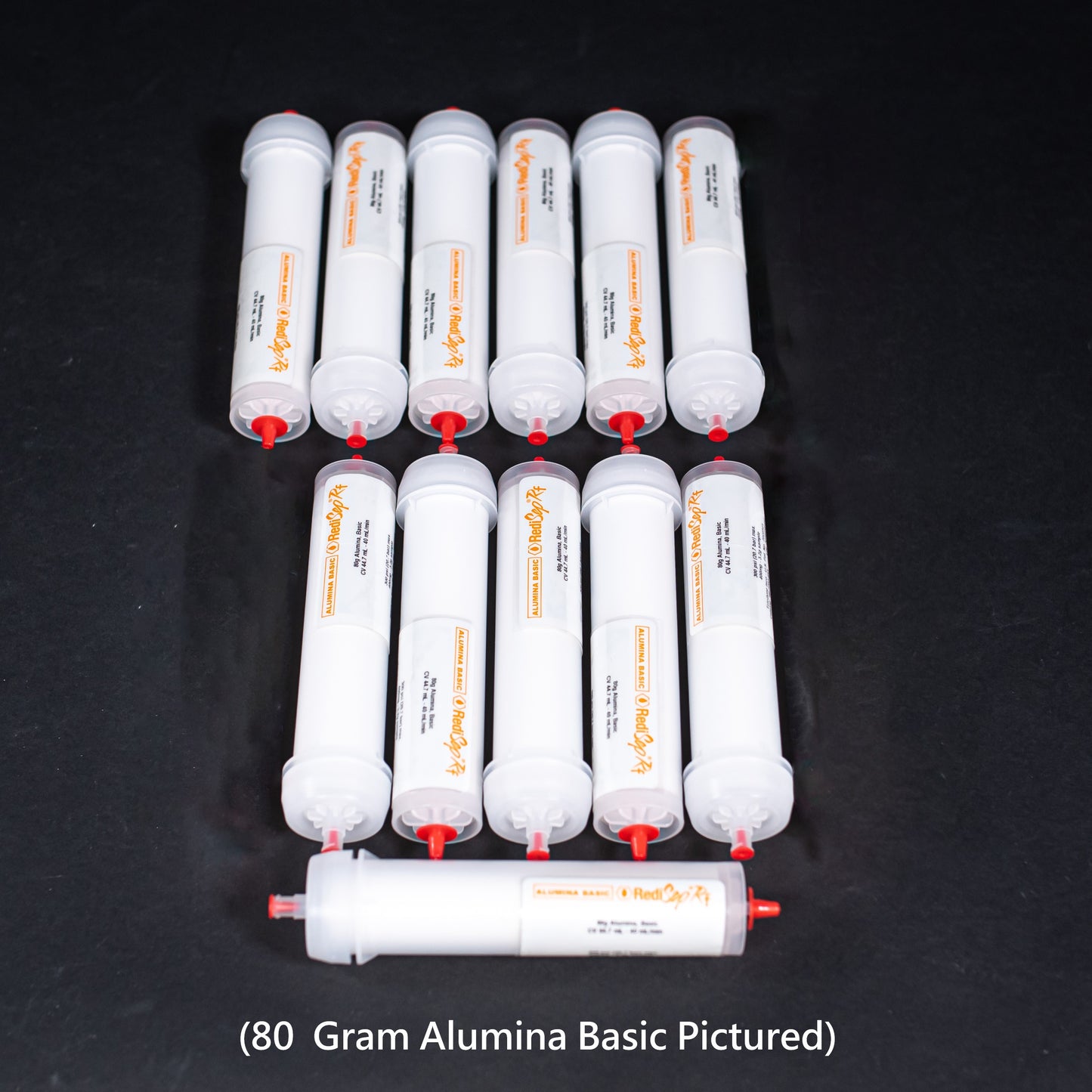 Set of white cylindrical objects with red caps. Text indicates 80 Gram Alumina Basic pictured.