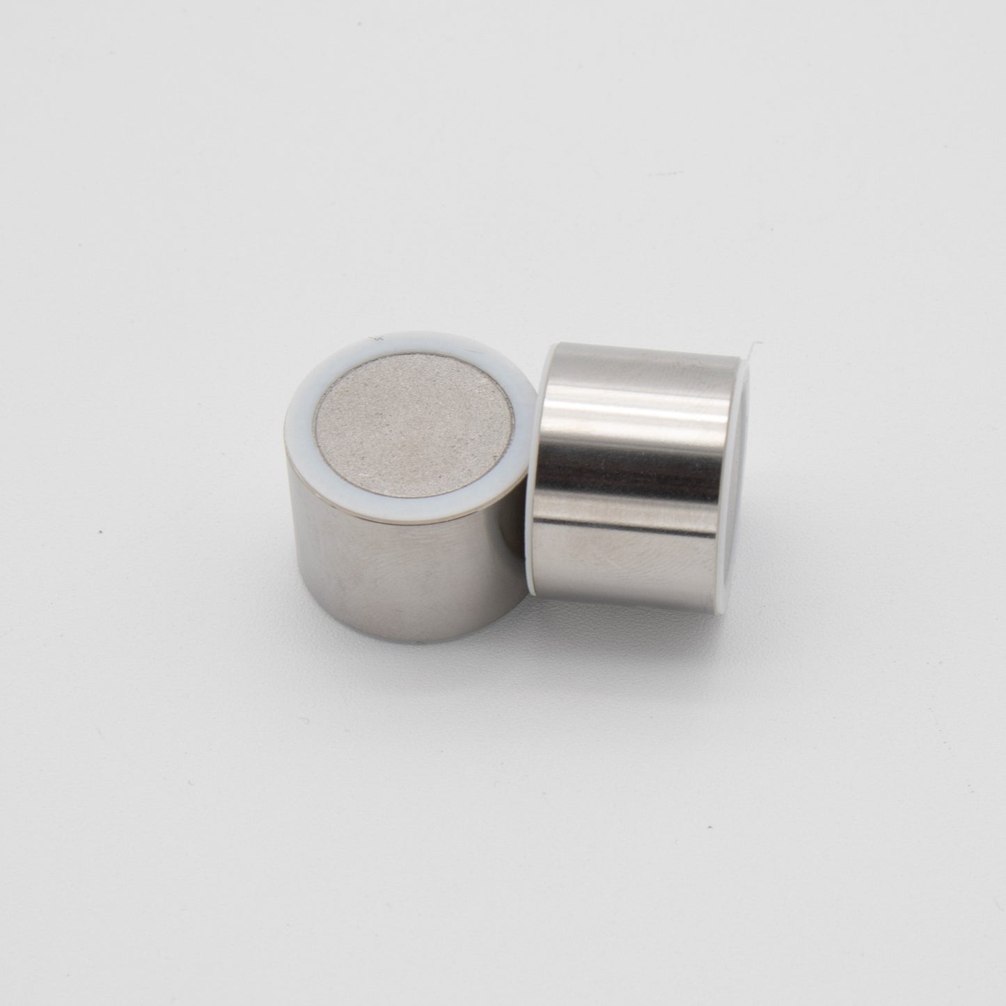 Two small metal cylinders, showcasing a sleek and modern design.