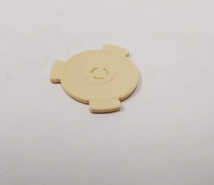 A small rotor featuring a circular design with three protruding spots.