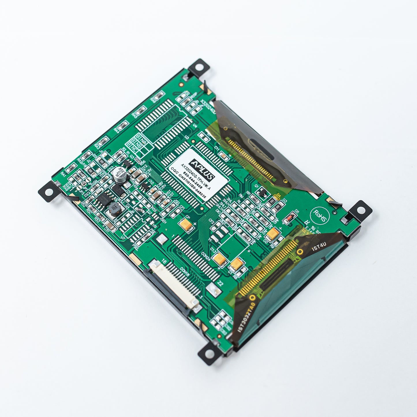 A close-up view of a motherboard resting on a white surface, showcasing intricate circuitry and components.