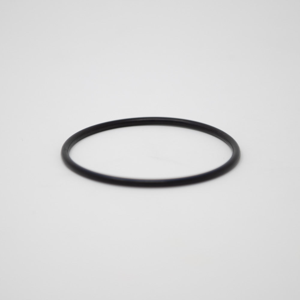 A simple black ring positioned on a clean white background, emphasizing the ring's shape and the stark color difference.