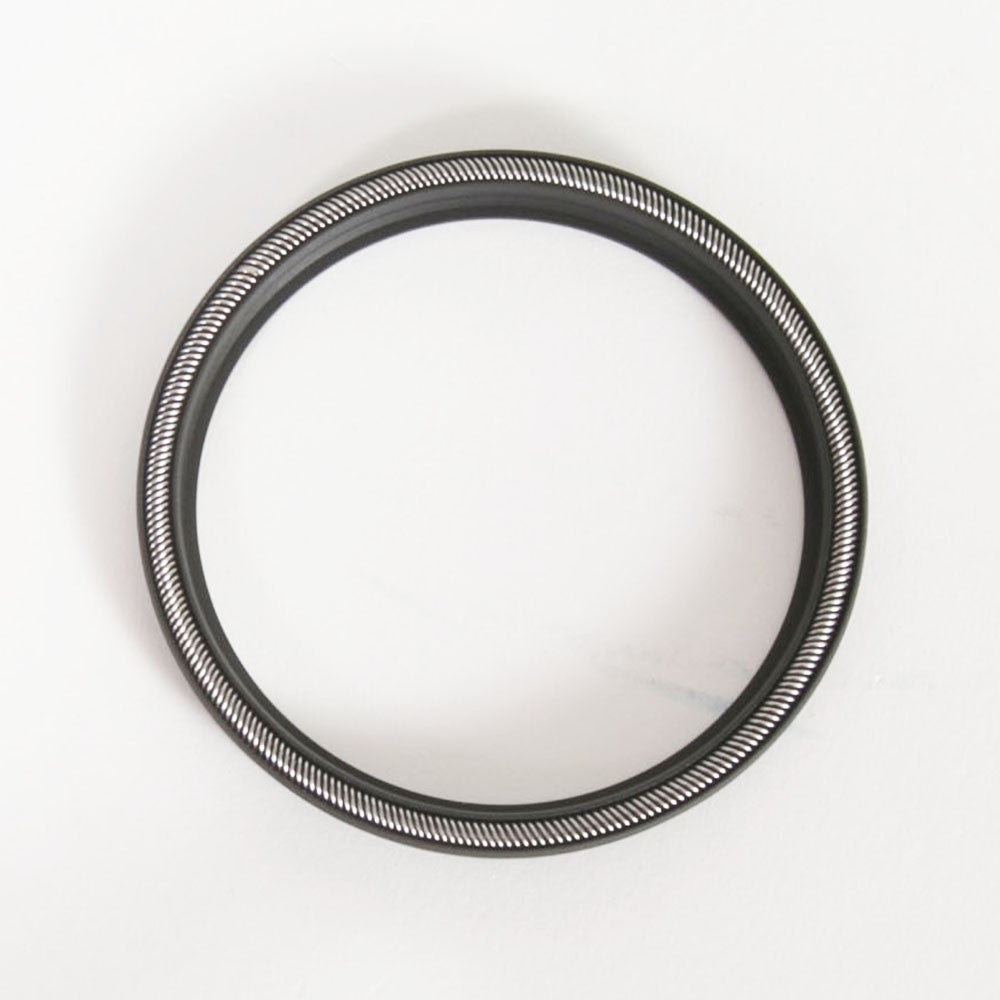 Close-up image of a round black seal on a white surface, emphasizing its sleek design.