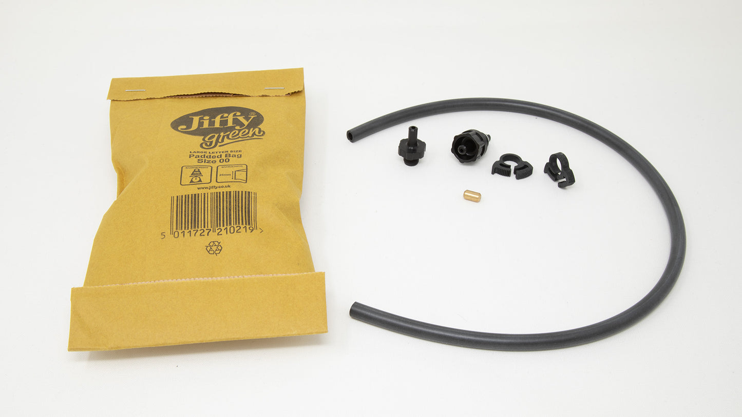 A black rubber hose and a bag of black rubber pieces arranged on a simple surface, emphasizing their textures.