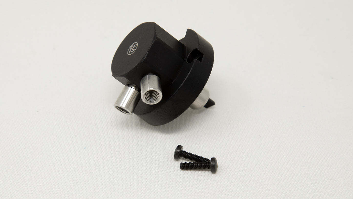A black plastic valve accompanied by screws, arranged neatly for assembly.