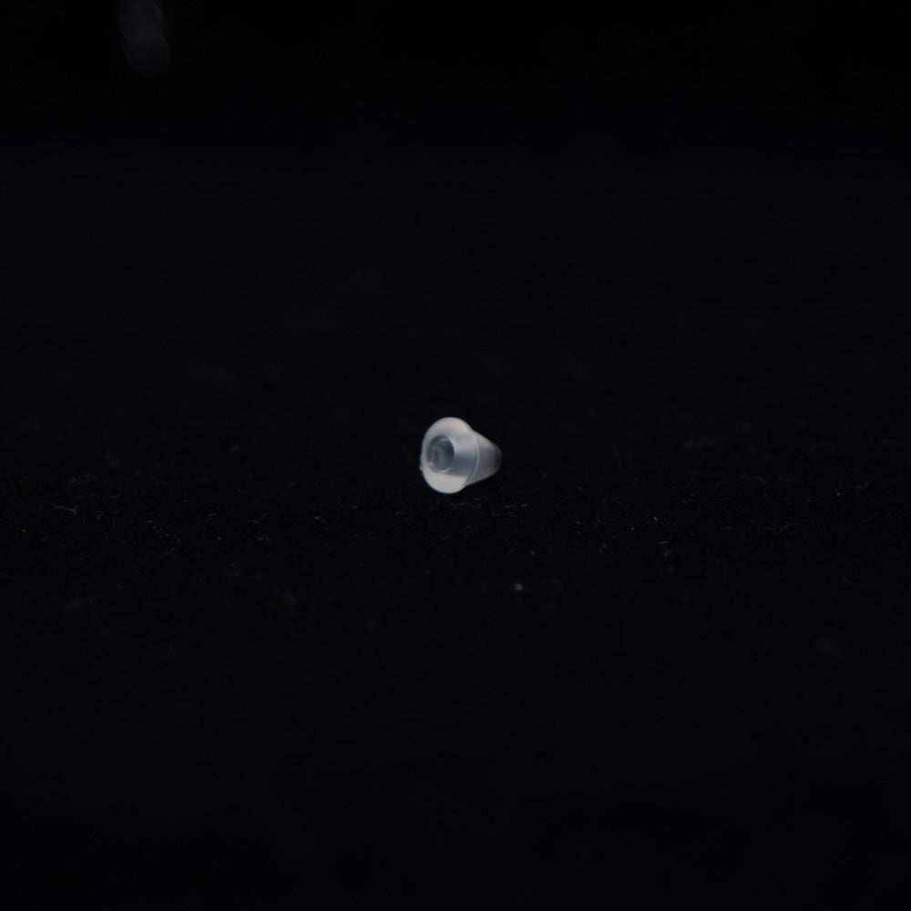 A small object rests on a smooth black surface, creating a striking contrast between the two colors.
