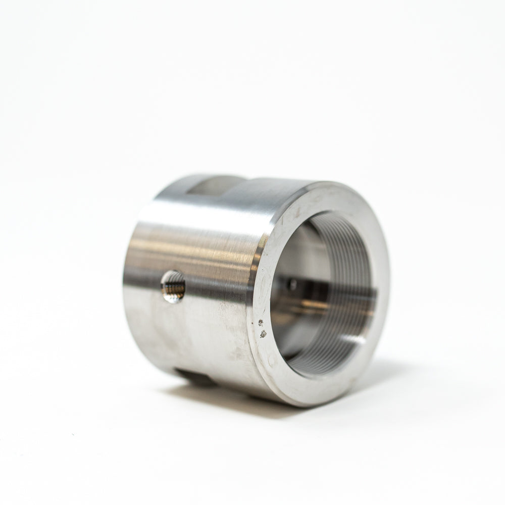A stainless steel cylinder with a circular hole, emphasizing its polished appearance and functional design.