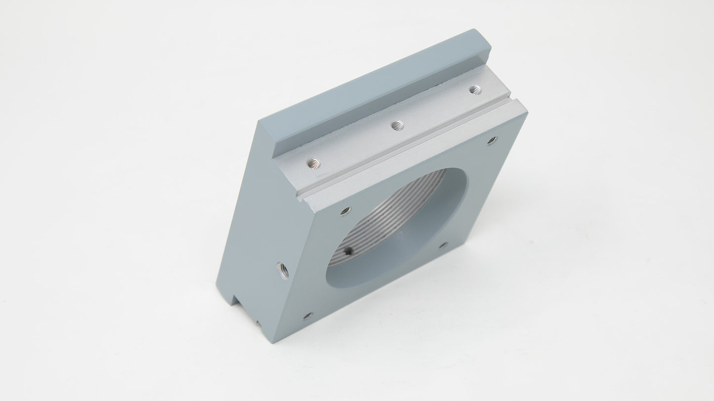 A gray square box featuring a circular hole in the center, showcasing a minimalist design.