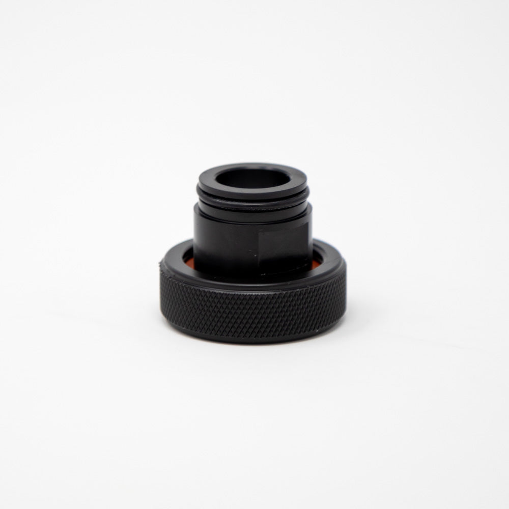 A black plastic cap featuring an orange rubber ring, designed for secure sealing and protection.
