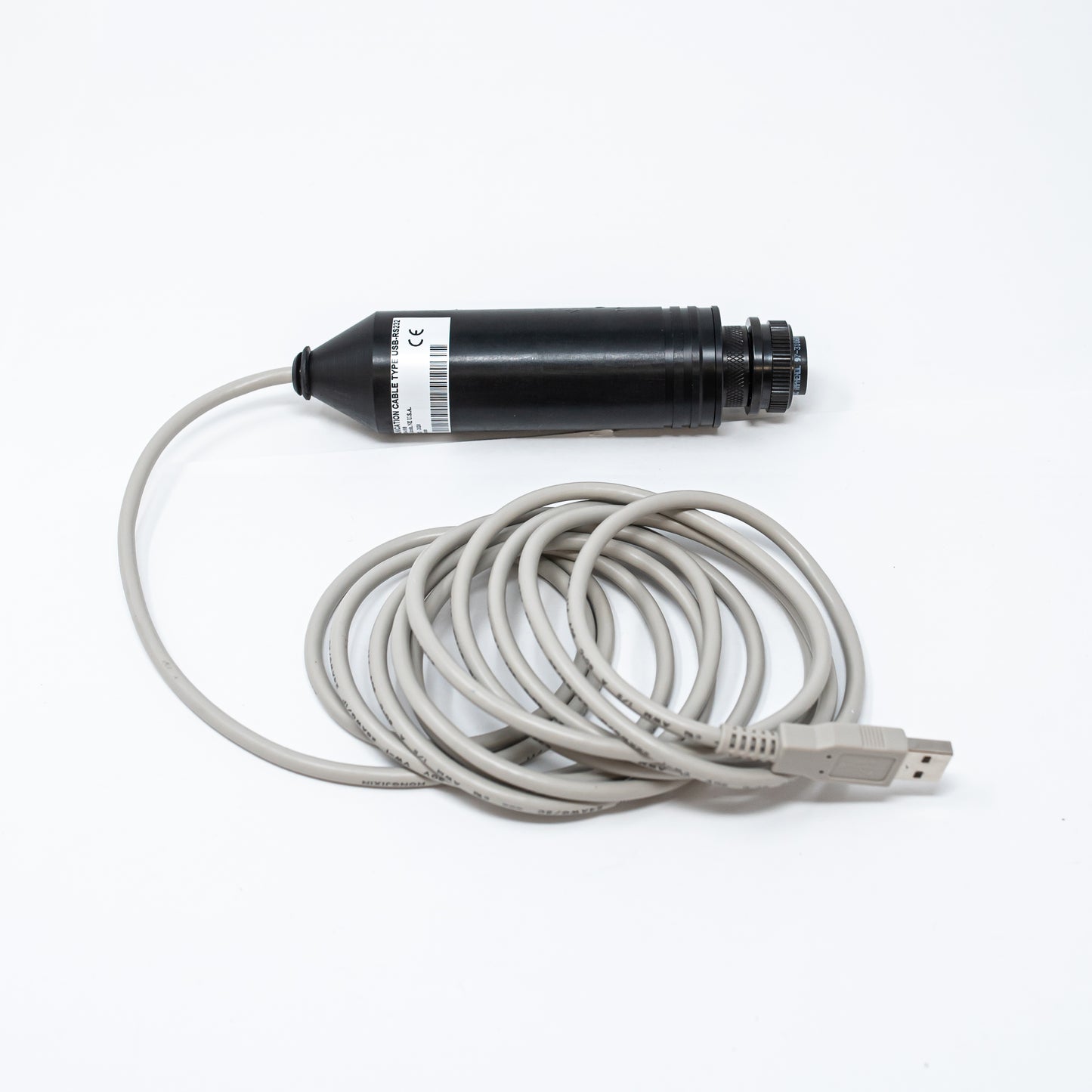 A black cylindrical shaped device with a tan USB cord attached, emphasizing a clean and efficient connection between the two elements.
