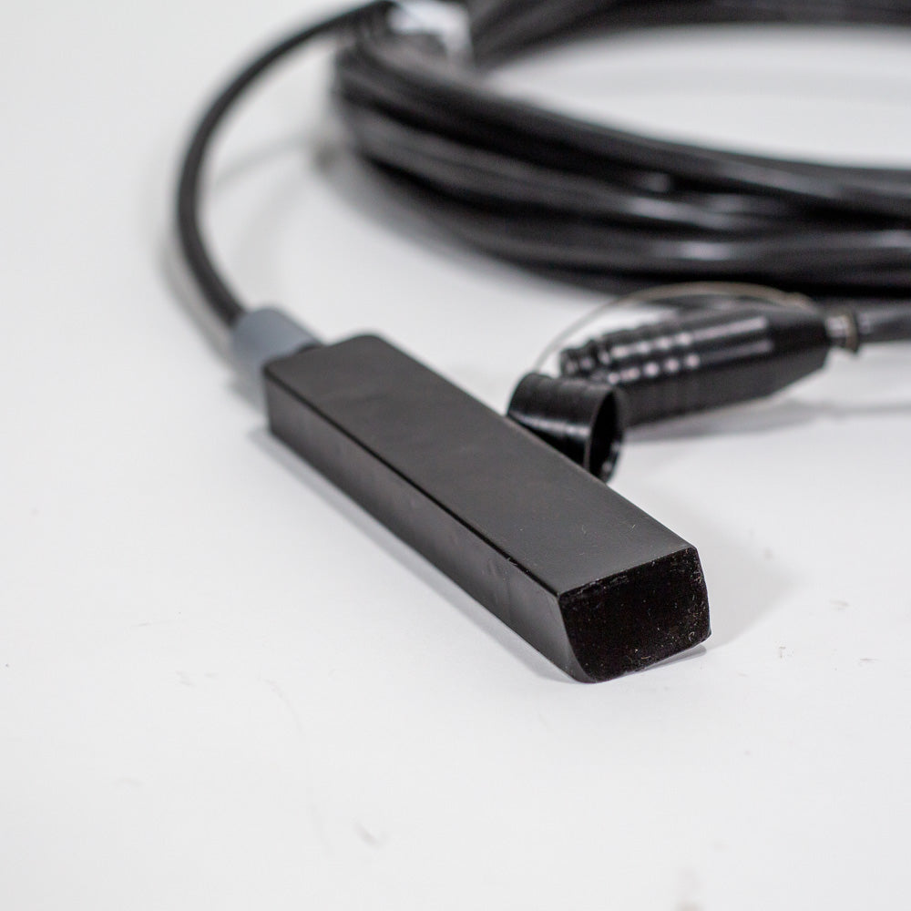 A black cable featuring a small black sensor, illustrating a basic connection in an electronic device.