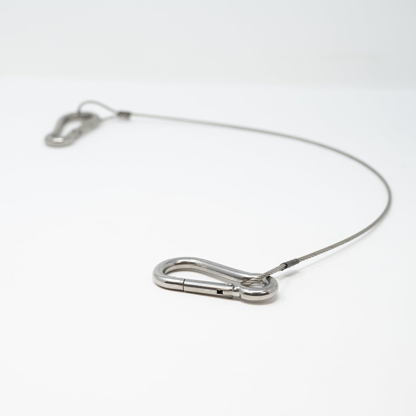 A pair of metal clips attached to a steel wire, showcasing their sturdy design and functionality for various applications.