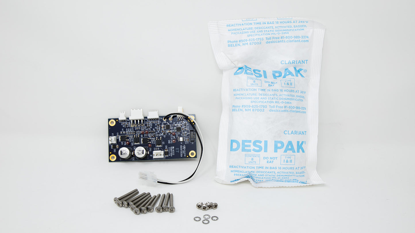 A compact electronic device accompanied by screws and a small bag, showcasing its portable and organized design.