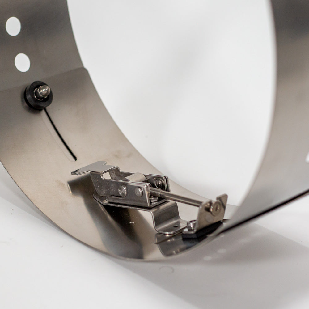 Close-up image of a metallic device equipped with a metal clamp, emphasizing its design and operational elements.